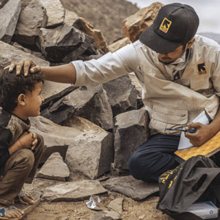 IRC volunteer with child